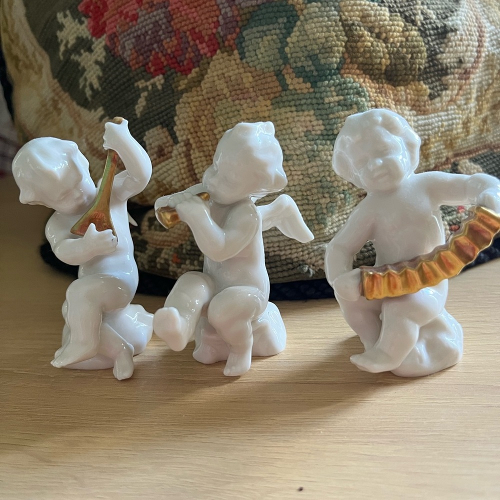 White Porcelain Cherub Figurine Trio with Gold Accents